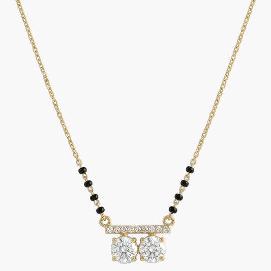 Gold necklace with diamond pendant on a white background