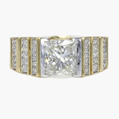 Diamond ring with a central square-cut diamond and smaller diamonds on a gold band against a white background