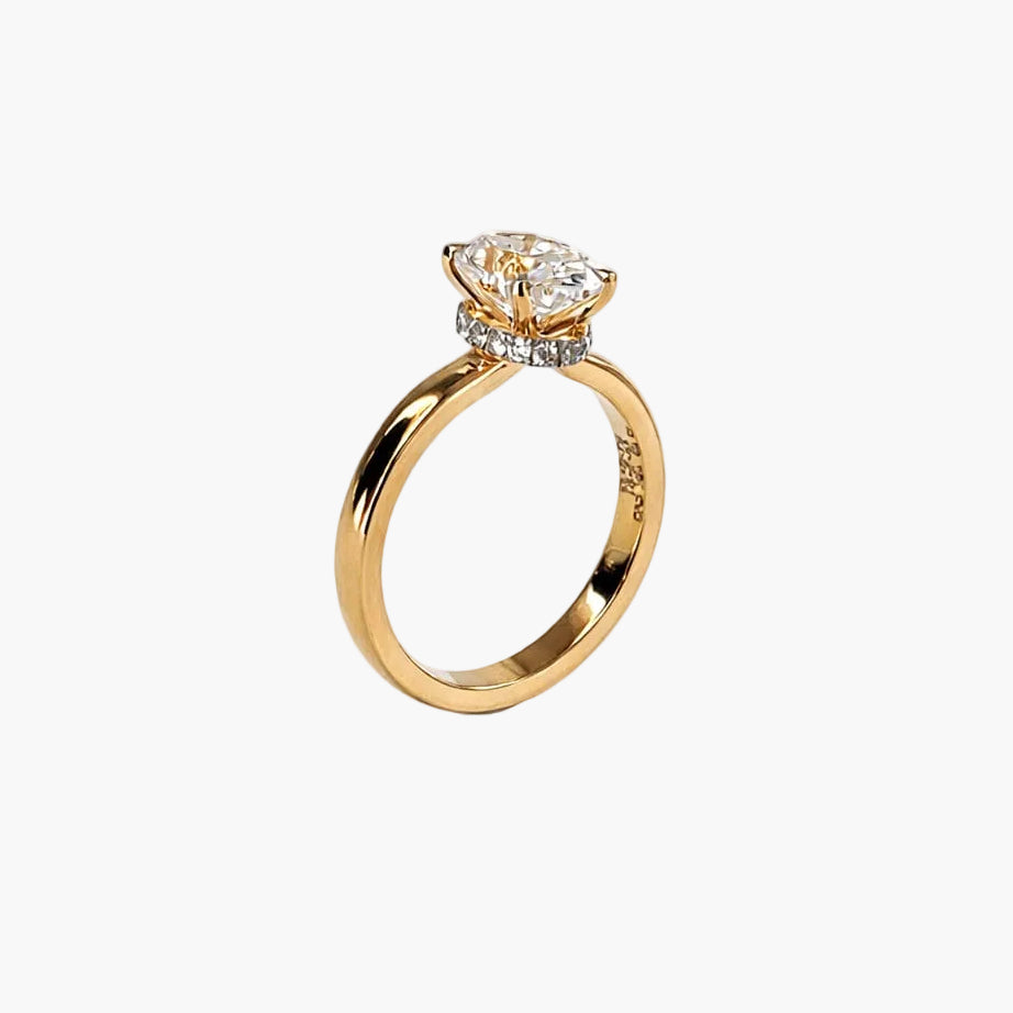 Gold ring with a diamond on a white background