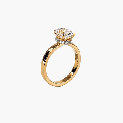 Gold ring with a diamond on a white background