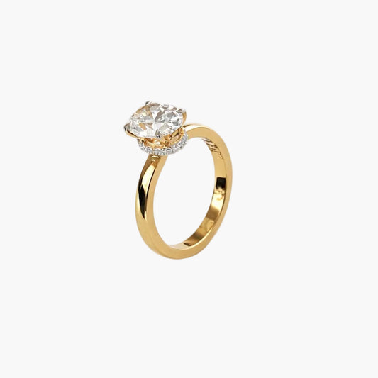 Gold ring with a diamond on a white background