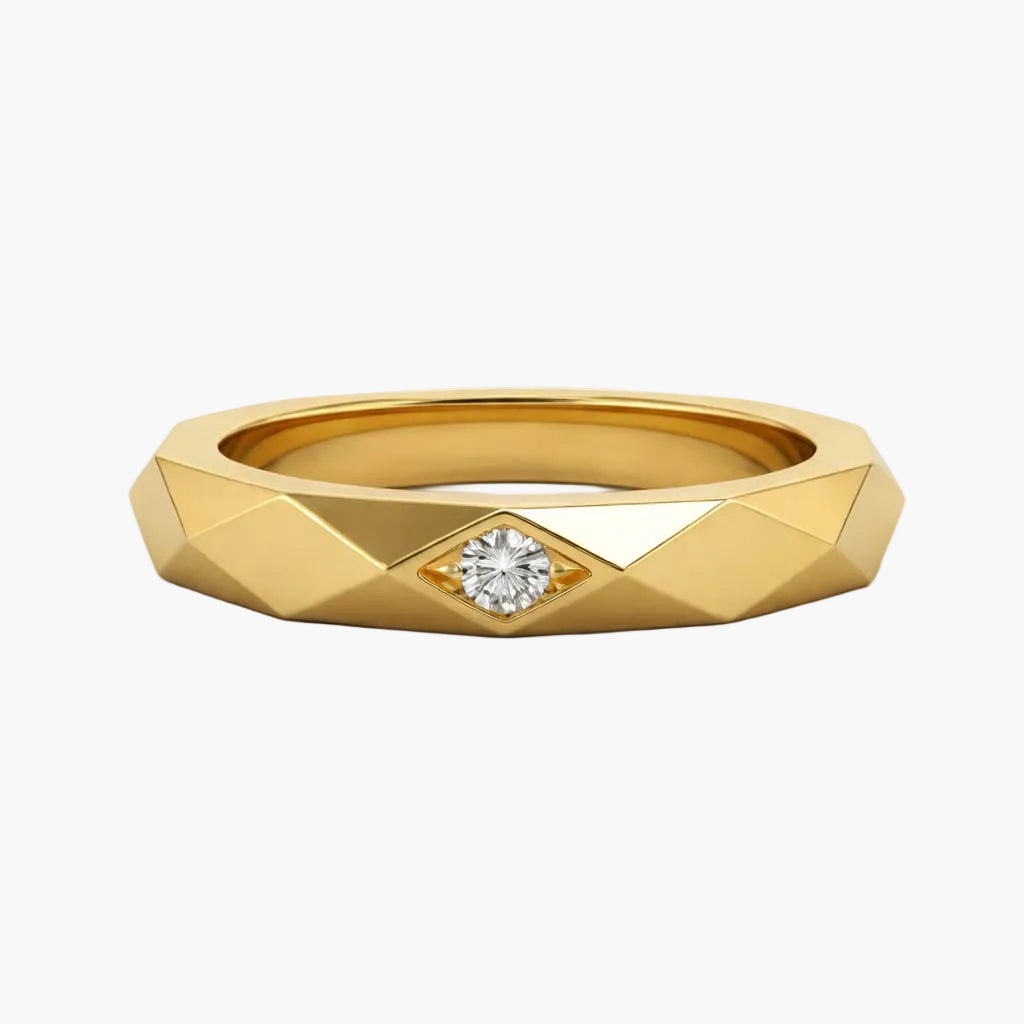 Gold ring with a diamond on a white background