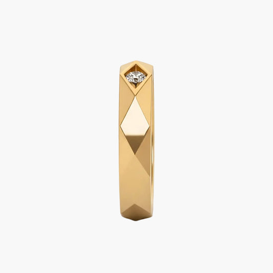 Gold ring with a diamond on a white background