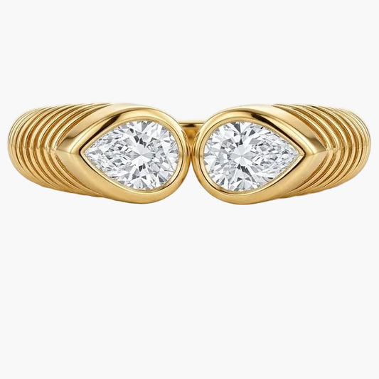 Set of gold rings with diamond accents on a light background