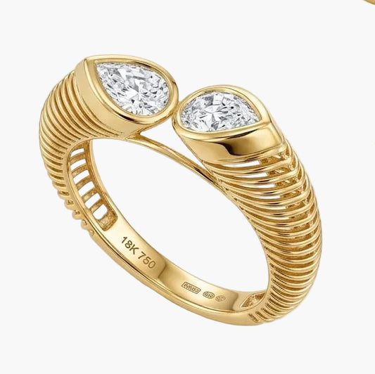 Set of gold rings with diamond accents on a light background