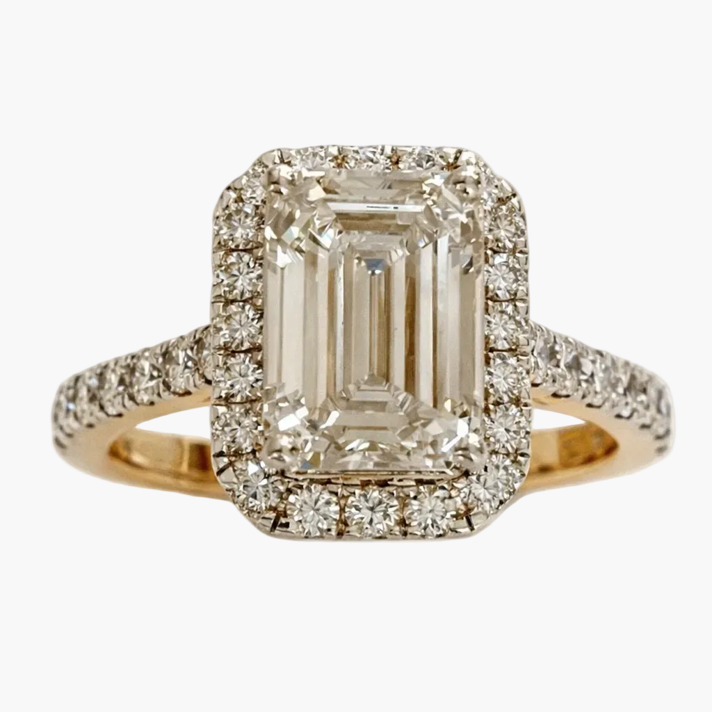 Diamond ring with emerald-cut center stone and smaller diamonds on a white background