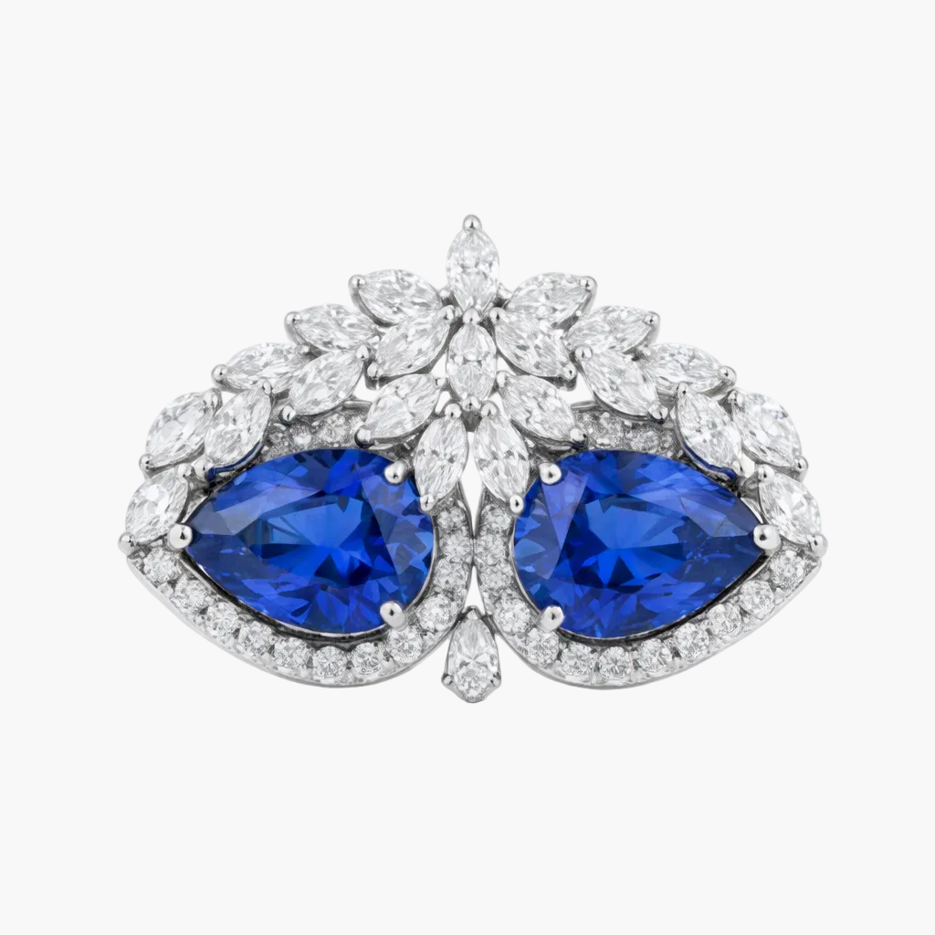 Pair of earrings with blue gemstones and diamond-like stones on a white background