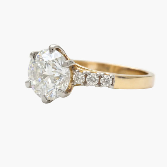 Diamond ring with gold band on a white background