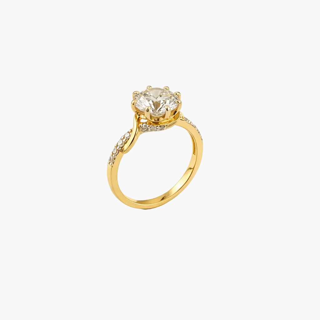 Gold ring with a large diamond and smaller diamonds on the band against a white background