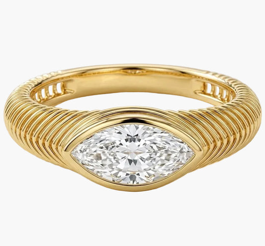 Gold ring with a diamond on a light background