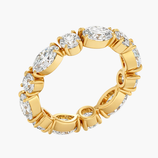 Gold ring with clear gemstones on a white background