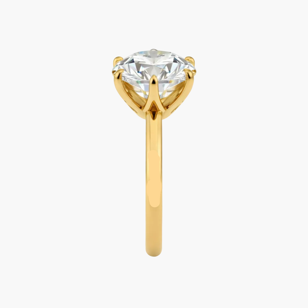 Gold ring with a large diamond on a white background