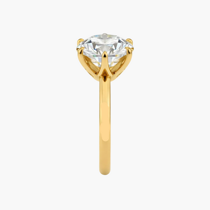 Gold ring with a large diamond on a white background