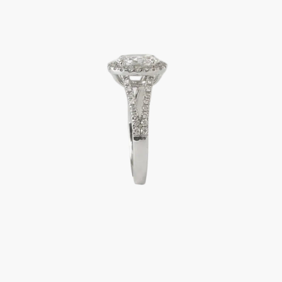 Silver ring with a diamond on a light gray background