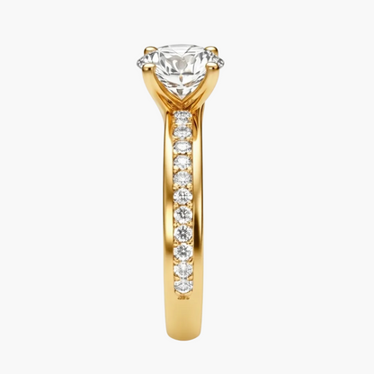 Gold ring with a large diamond and smaller diamonds on the band against a white background