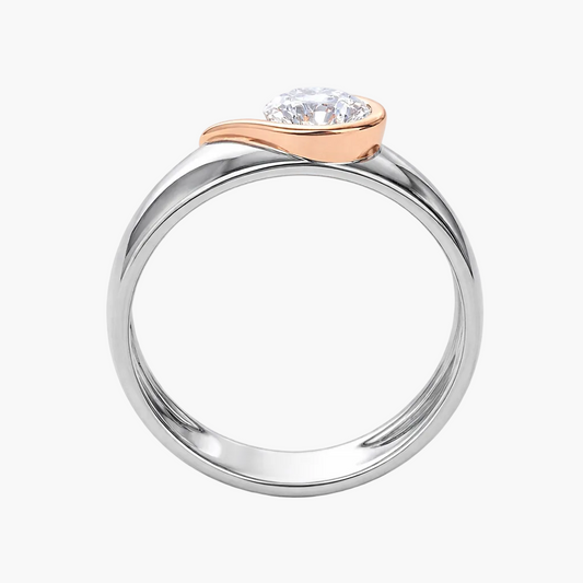 Two-tone ring with a diamond on a white background