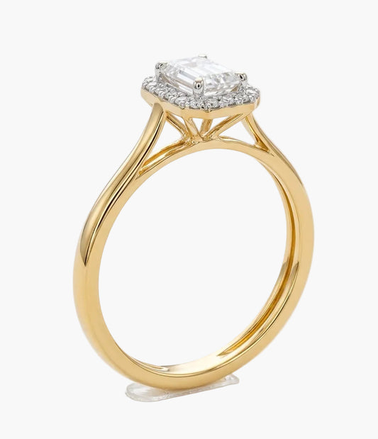 Gold ring with a diamond on a white background