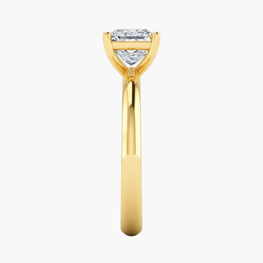 Gold ring with a heart-shaped diamond on a white background