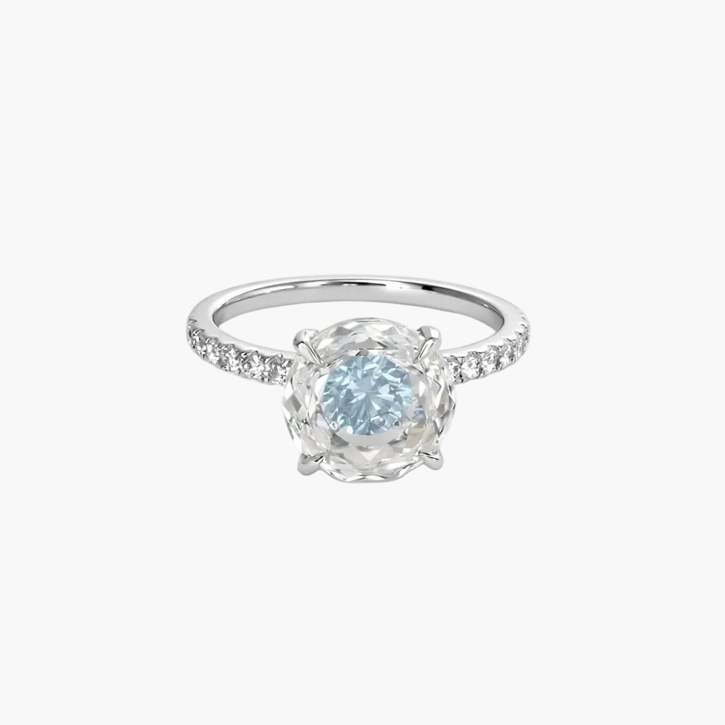 Silver ring with a blue gemstone on a white background