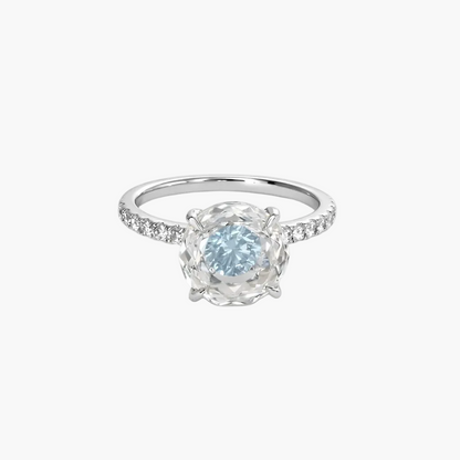 Silver ring with a blue gemstone on a white background