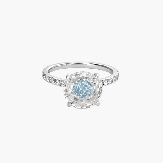 Silver ring with a blue gemstone on a white background
