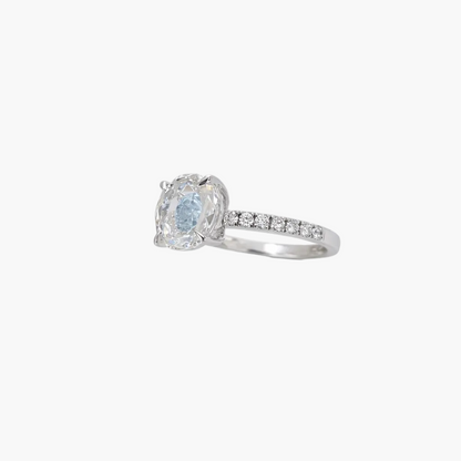 Silver ring with a blue gemstone and diamond accents on a white background