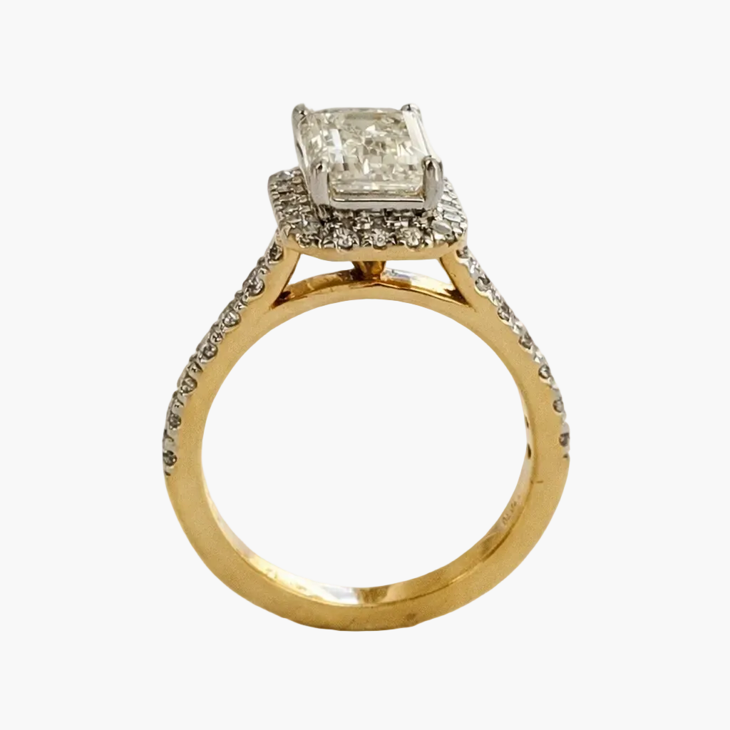 Gold ring with a diamond on a white background