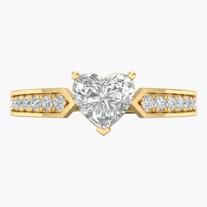Gold ring with a heart-shaped diamond and smaller diamonds on the band against a white background