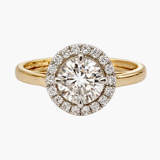 Gold ring with a large diamond and smaller diamonds around on a white background