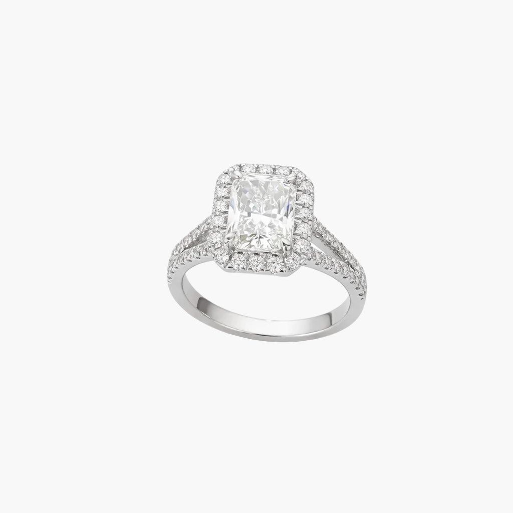 Diamond ring with a rectangular center stone on a white background