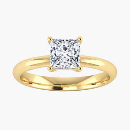 Gold ring with a princess-cut diamond on a white background