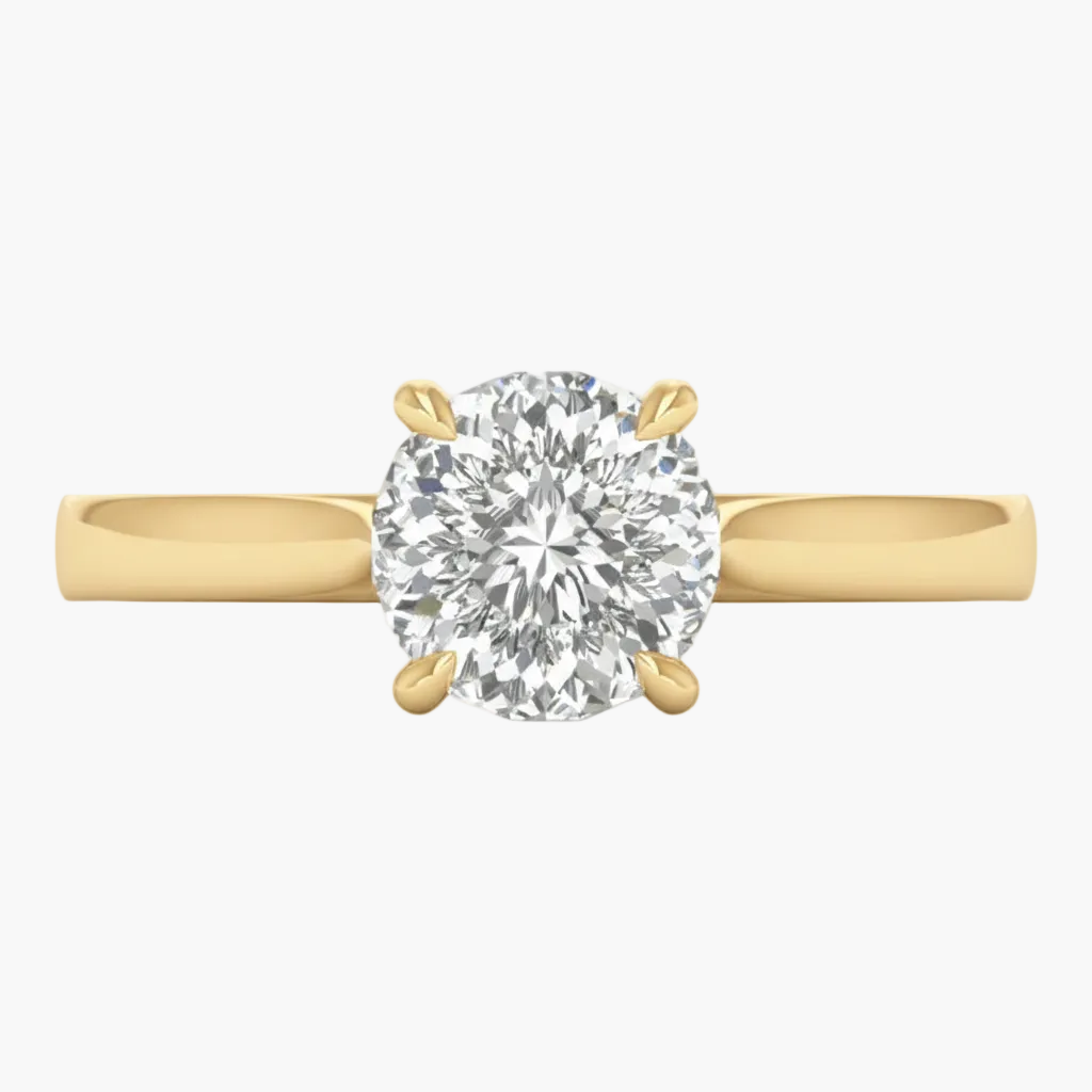 Gold ring with a large diamond on a light gray background