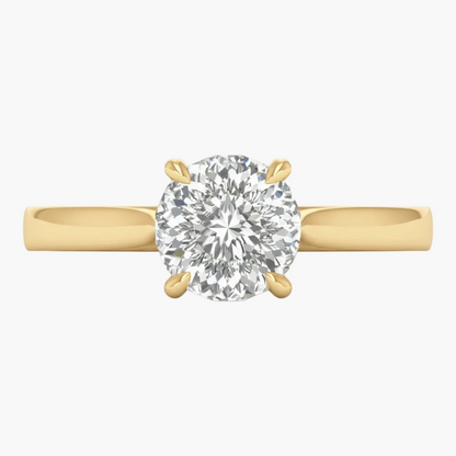 Gold ring with a large diamond on a light gray background