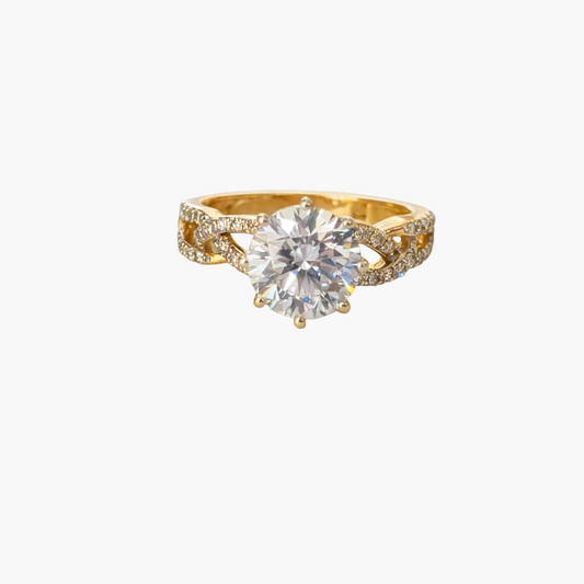 Gold ring with a large diamond on a light gray background