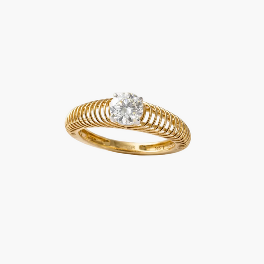 Gold ring with a diamond on a light gray background