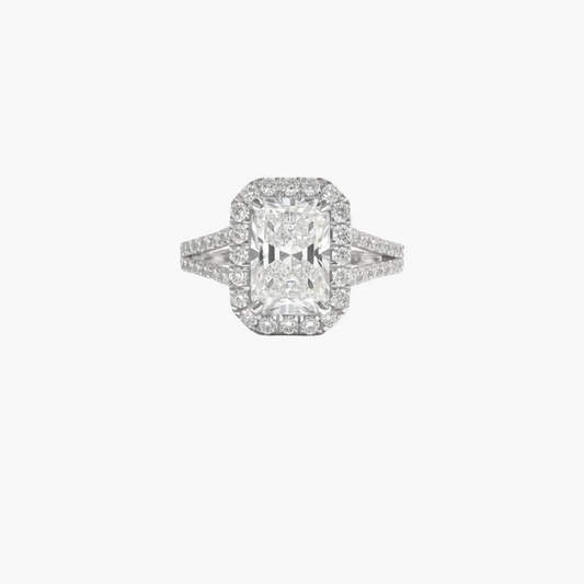 Diamond ring with a rectangular center stone on a white background
