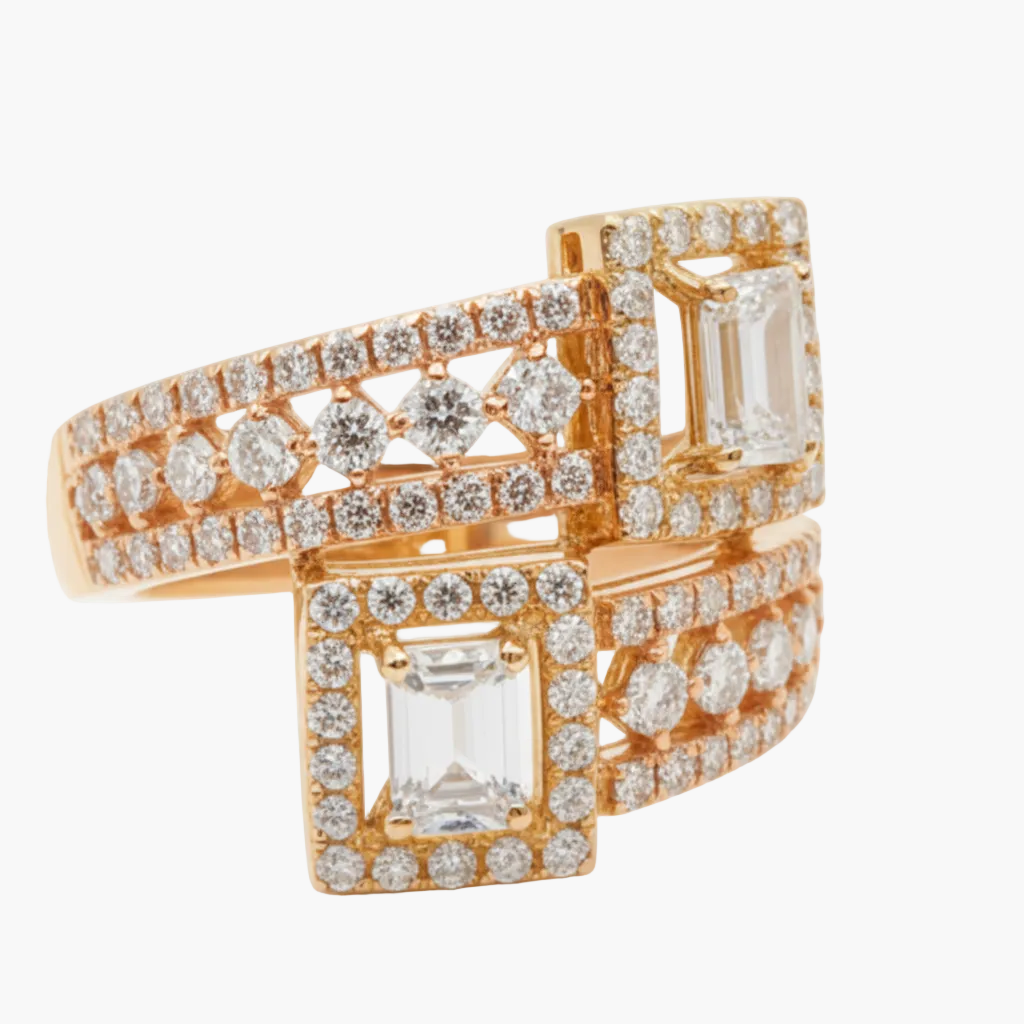 Rose gold ring with emerald-cut gemstones and diamond accents on a white background