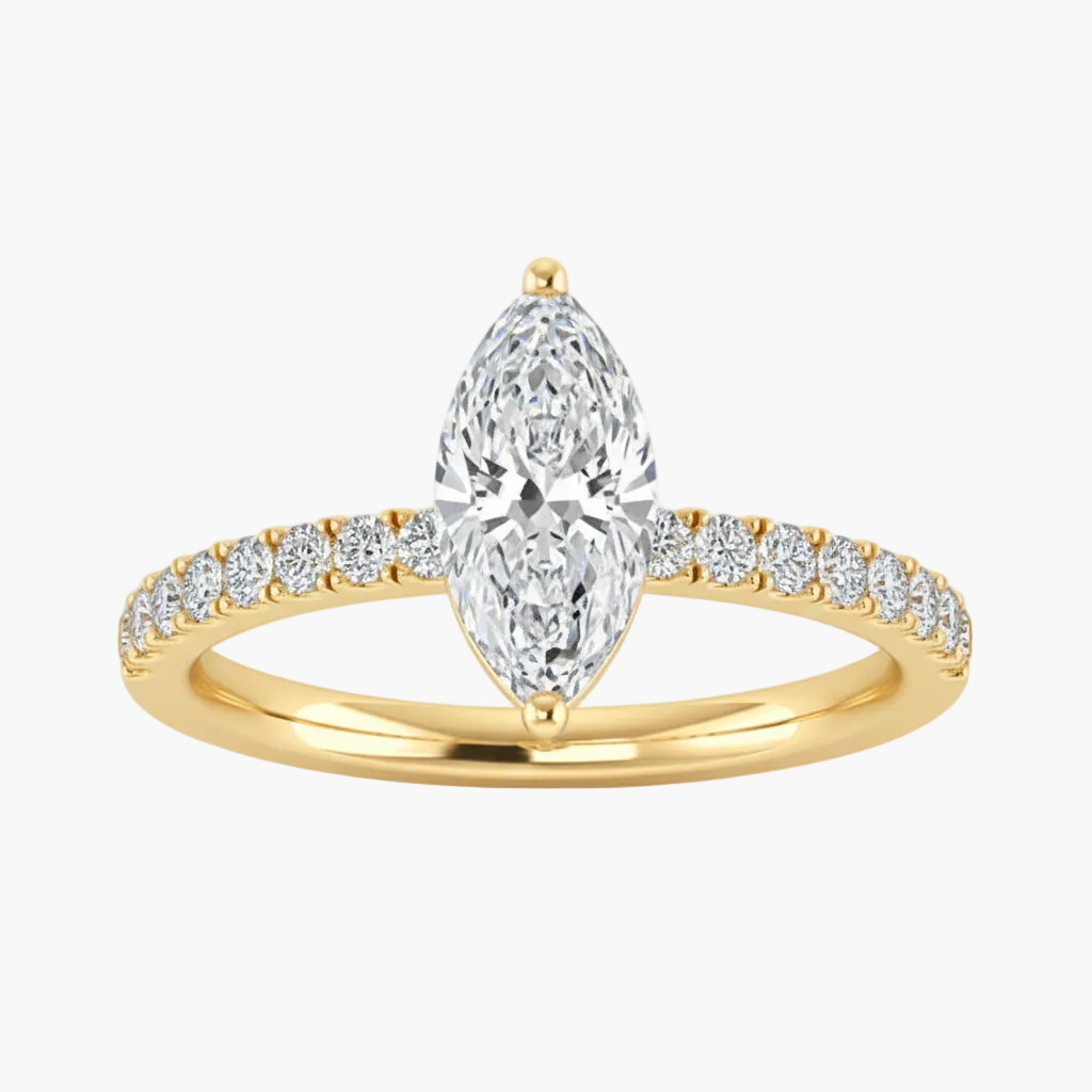 Gold ring with a pear-shaped diamond and smaller diamonds on a white background