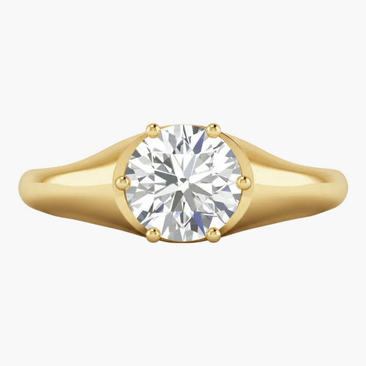 Gold ring with a diamond on a white background