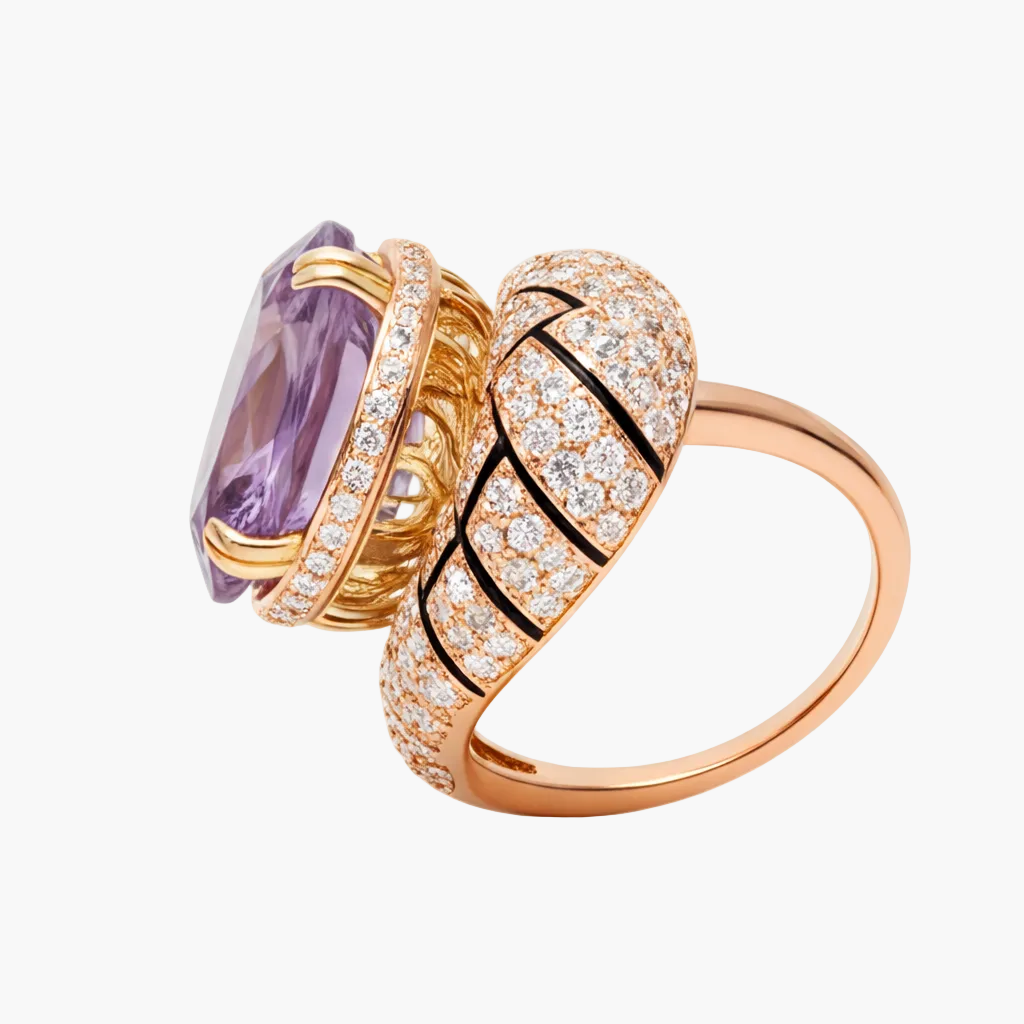 Luxury ring with purple gemstone and gold band on a white background