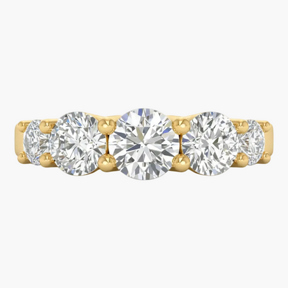 Gold ring with five round diamonds on a white background