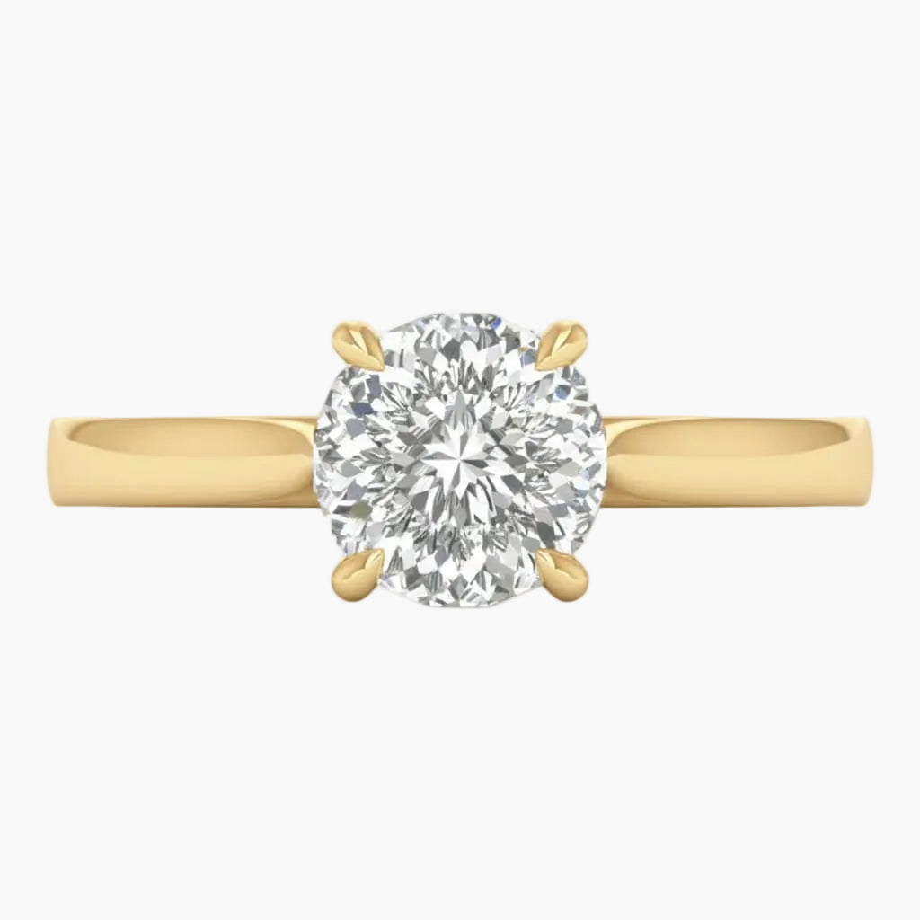 Gold ring with a large diamond on a light gray background