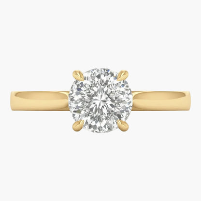 Gold ring with a large diamond on a light gray background