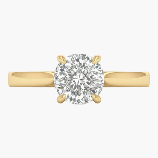 Gold ring with a large diamond on a light gray background