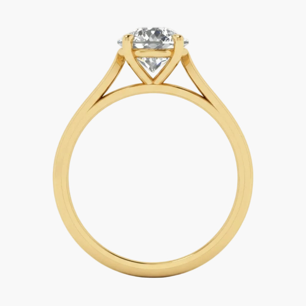 Gold ring with a diamond on a light gray background