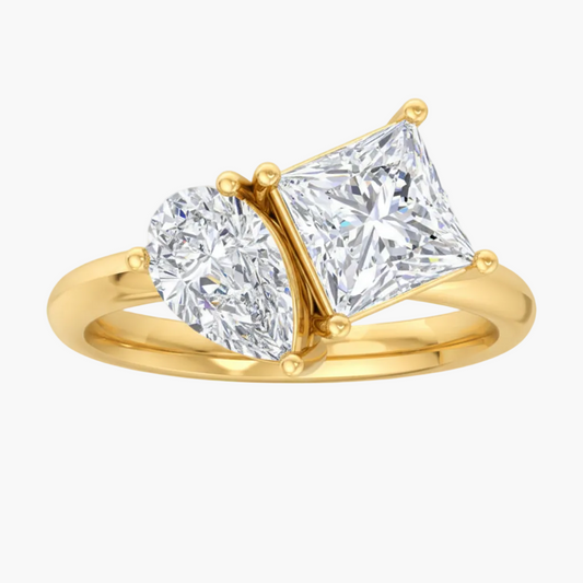 Gold ring with two diamonds on a white background