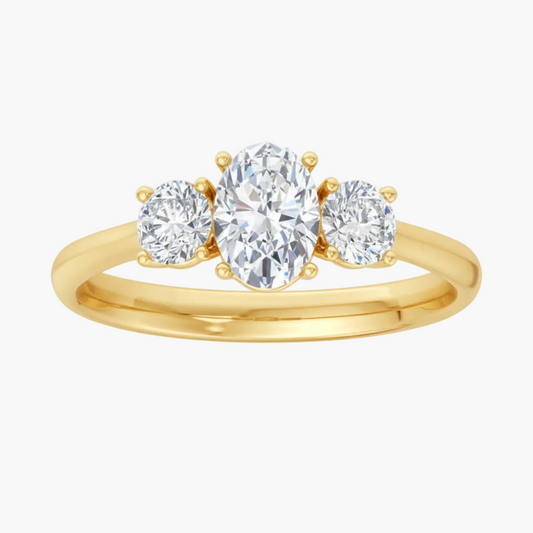 Gold ring with three diamonds on a white background