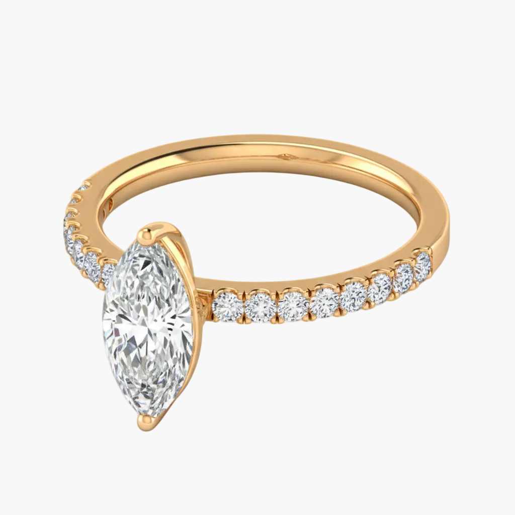 Gold ring with a pear-shaped diamond on a white background