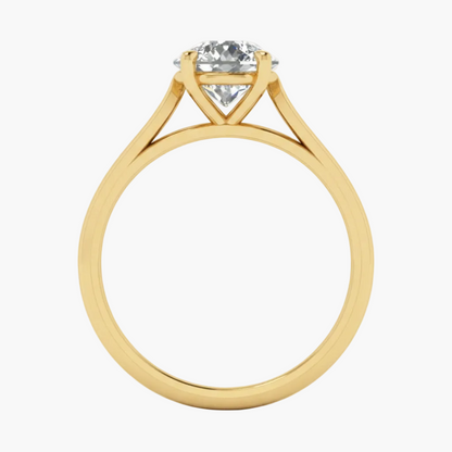 Gold ring with a diamond on a light gray background