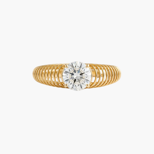 Gold ring with a diamond on a light gray background